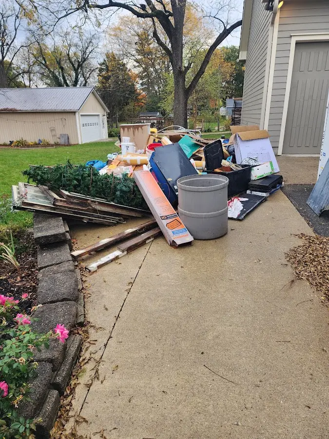 Dumpster being loaded with debris for Estate Cleanout Dumpster Rental in McCandless